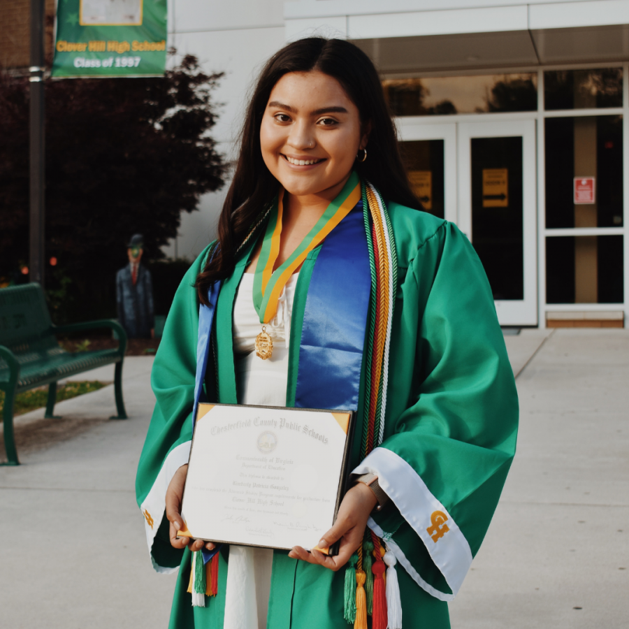 Graduate Kimberly González proudly holds her diploma.