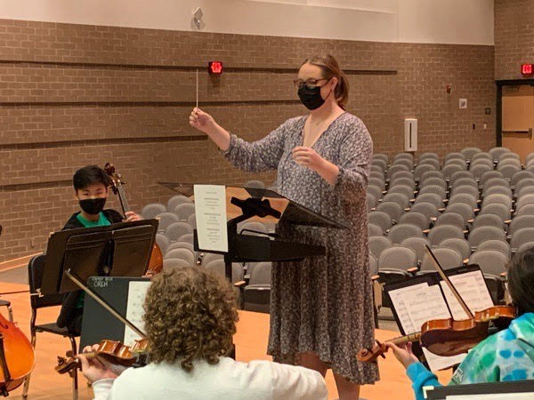 Orchestra teacher Hannah Grooms conducts her students as they prepare for their fall concert.