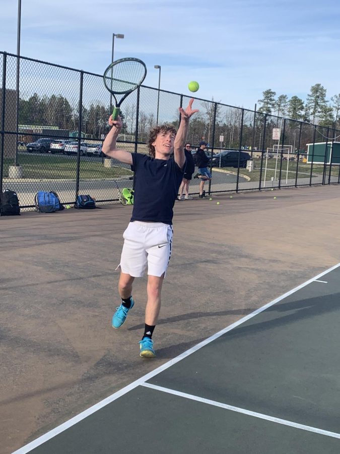 Junior Peter Squarzini serves the ball at an early season practice. 