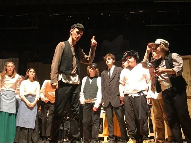Junior Charlie Elliot (center) and other members of the cast performing.