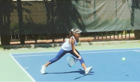 Chaudry swings her racket and prepares to strike the ball during a match. 
