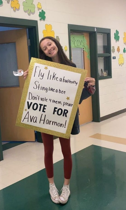 Harmon stands in the hallway with one of the campaign posters that she made.