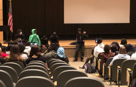 Students holding a discussion and forum in the auditorium after walking out.