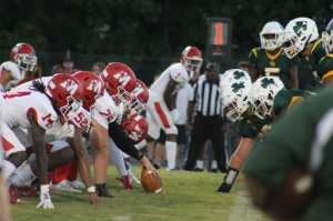 Clover Hills defensive line face up against the Warriors offensive line prior to the snap.