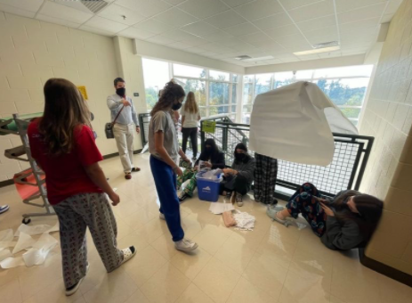 Hand and the other class of 2025 officers work on decorating their stairwell during homecoming week last year.