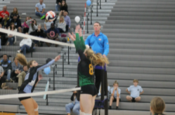 Junior Addison Thompson goes up for a block against a Cosby spiker.