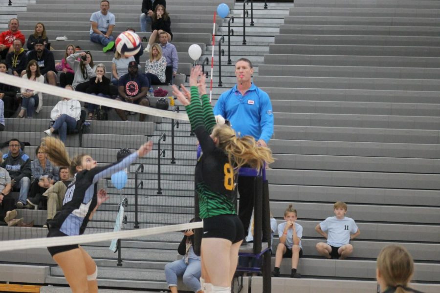 Junior Addison Thompson goes up for a block against a Cosby spiker.