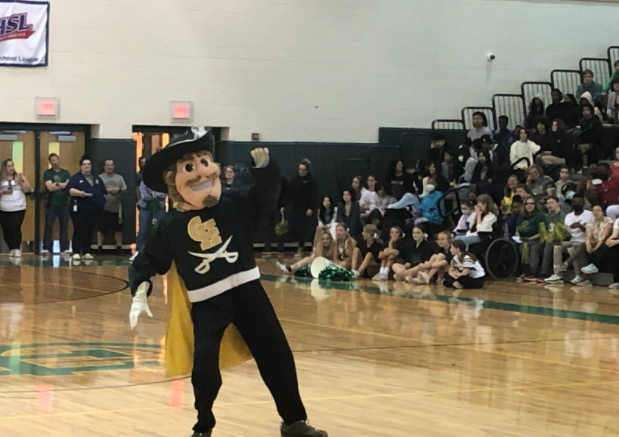 Cav Man appears at a pep rally for the first time in five years, hyping up the crowd. The mascot recently returned to Clover Hill and is played by students whose identities are unknown. 