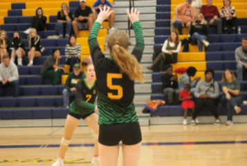 Senior Izzy Carter sets up junior teammate Alyssa Thompson for a spike