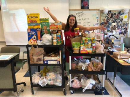 Clopton shows off the donations collected in the food drive.