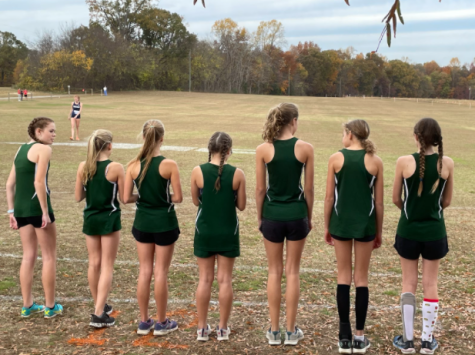 The varsity squad stands on the line before the start of the race.