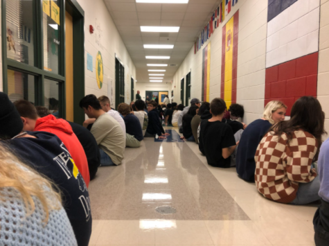 Students face the wall in an interior hallway on the first floor to protect against tornadoes.
