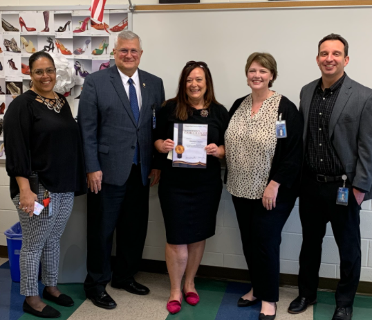 English teacher Rhonda Clopton (center) accepting the Superintendent’s Game Changer Award from superintendent Dr. Mervin Daugherty.