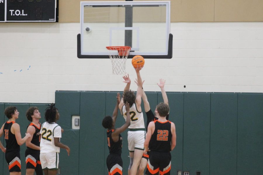 Senior Bryce Matthews goes up against two defenders to lay up the ball.