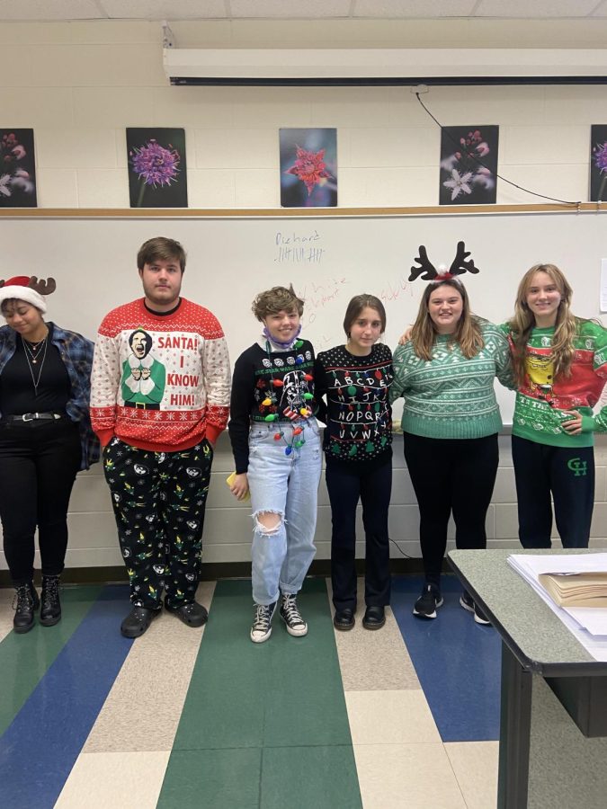 Juniors stand at the head of Rhonda Cloptons English class to show off their holiday outfits for Deck the Halls day.