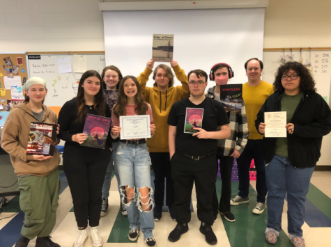 Waidelich and students in the creative writing classes with their magazines and awards. 