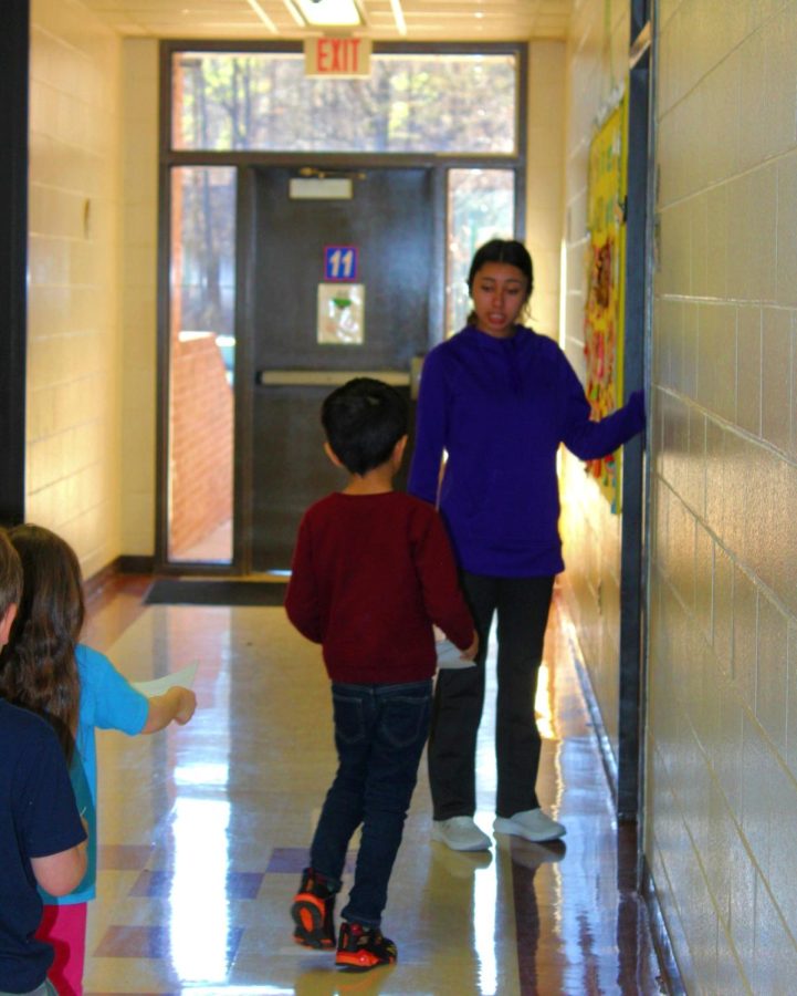 Katelynn Menjivar directs her students into the classroom coming from recess.
