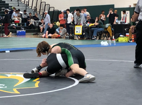 Jace DeAngelis attempts to pin his opponent during his finals match for the 120 pound division.