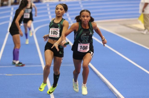 Torie Satterwhite hands the baton off to Kyra Williams during the 4 by 200 meter relay.