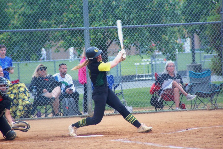 Junior Addison Thompson swings at a pitch thrown down the middle of the plate.