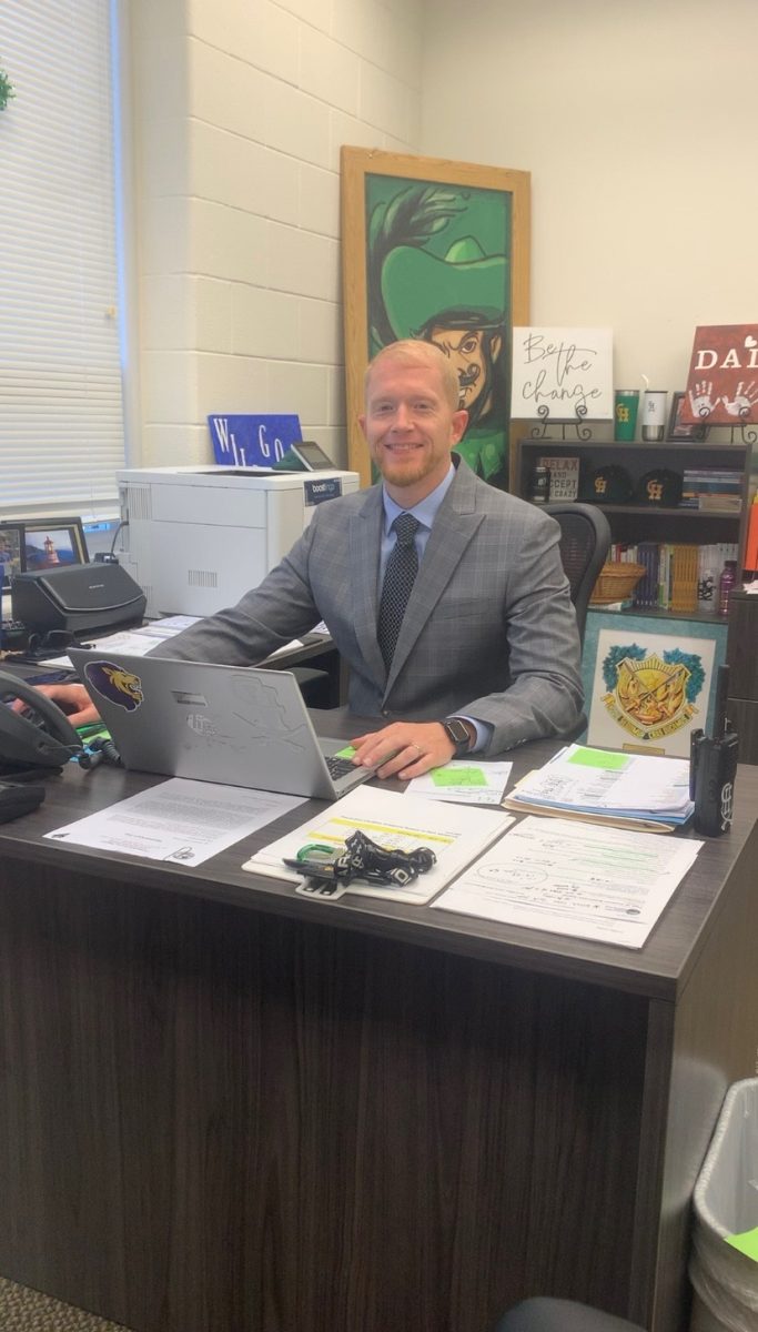 Altizer sitting at his desk