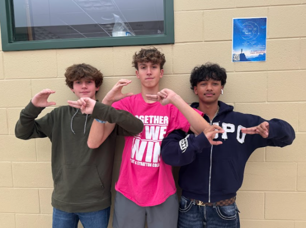 Left to right: Coleman James, Miles Adams, and Phoenix Singh signing "CH" for Clover Hill.