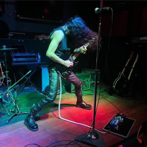 TORTURETWINN guitarist Andrew Devin solos at a local show. 