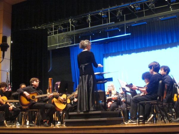 Orchestra and guitar teacher Teresa Maclin  conducting her guitar ensembles.