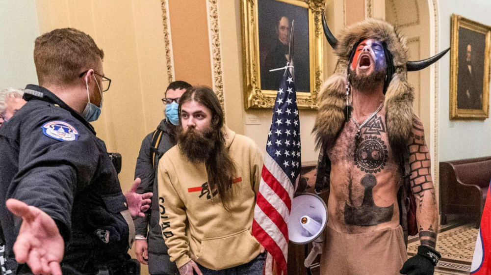 The “QAnon shaman,” Jacob Chansley, who was part of the infamous January 6th Capitol riot, along with other followers of the hateful ideology born on 4Chan. (source: ABC News)