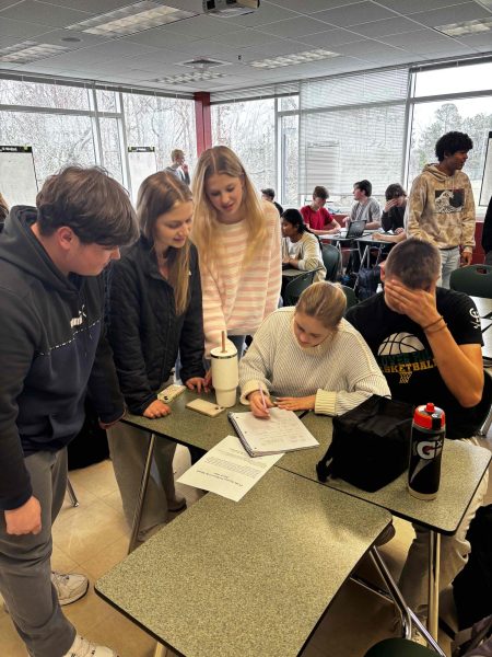 Mu Alpha Theta members attempting to solve a complex math problem. 