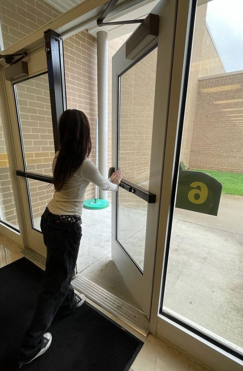 Student opening a door to leave school before the day is over