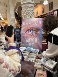 Display of the 'Watch Me' book cover and other books in the 'Shatter Me' series at Tahereh Mafi’s book premiere.