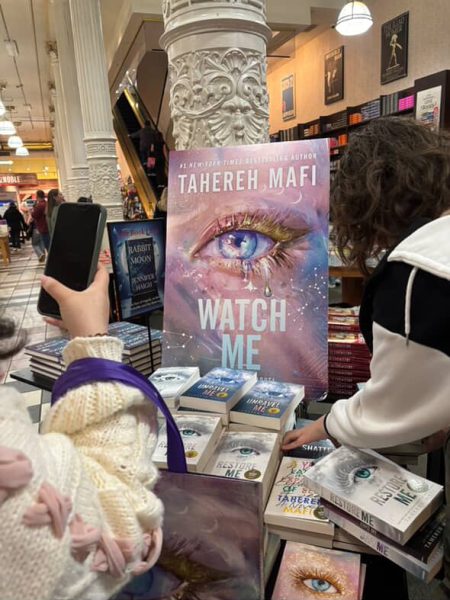 Display of the 'Watch Me' book cover and other books in the 'Shatter Me' series at Tahereh Mafi’s book premiere.