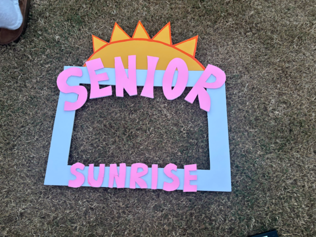 Senior buddies on a picnic blanket, getting ready to watch the sunrise. 