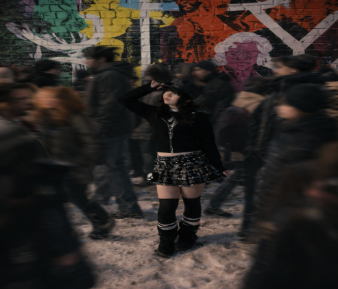 Alexis Garabedian poses amidst a crowd, creating a motion blur effect.