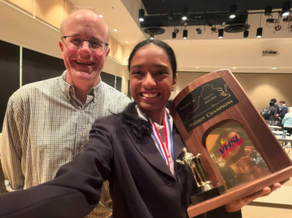 Gogineni poses with debate medals and debate coach Hunter Clark
