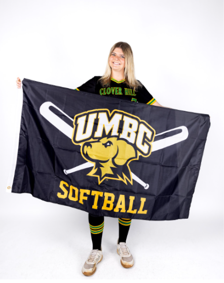 Miller posing for a picture showing off her UMBC flag
